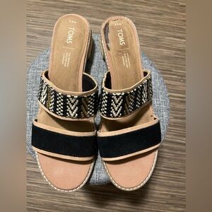 TOMS black geometric sandals. Spot on left shoe Sandals still in great condition
